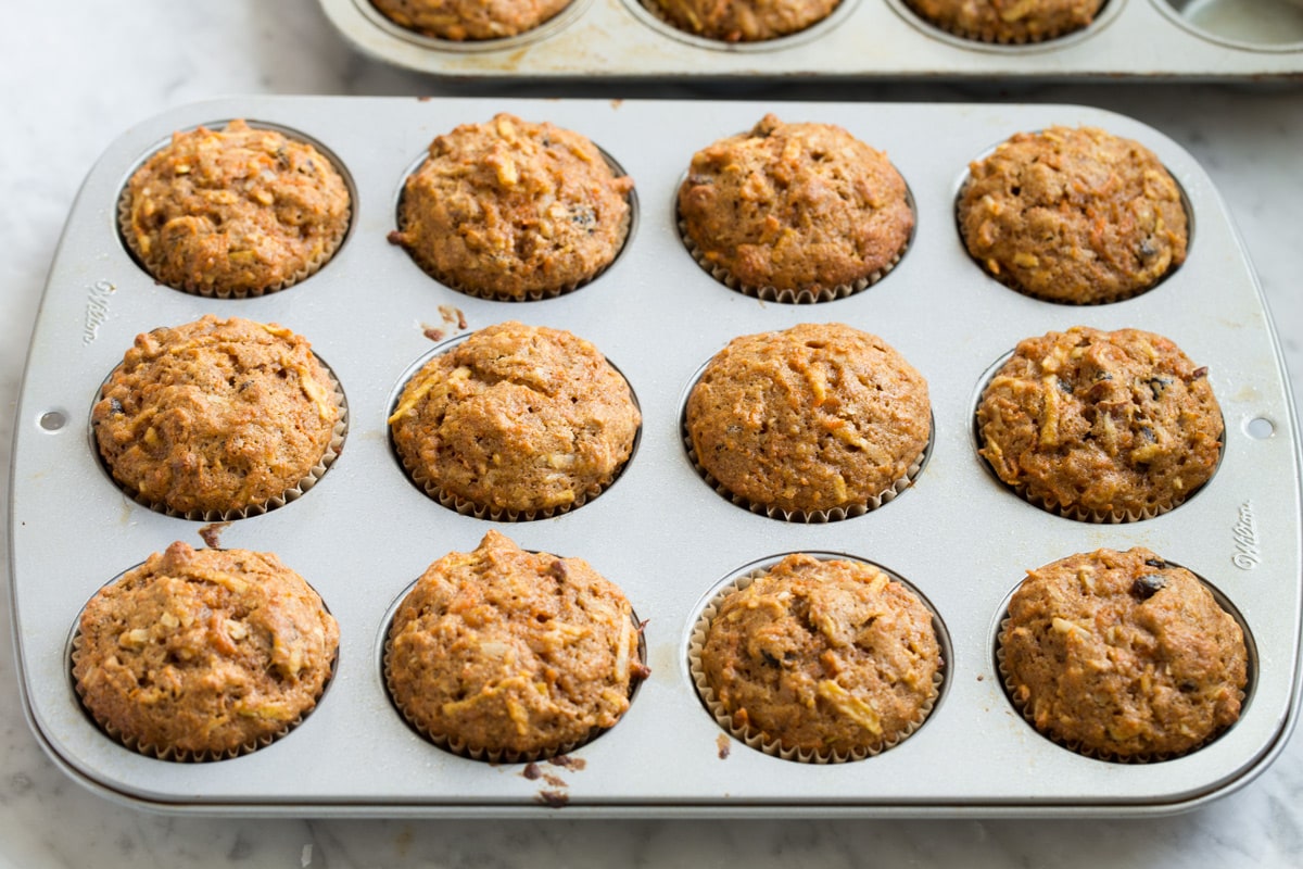 Morning glory muffins in a muffin pan after baking.