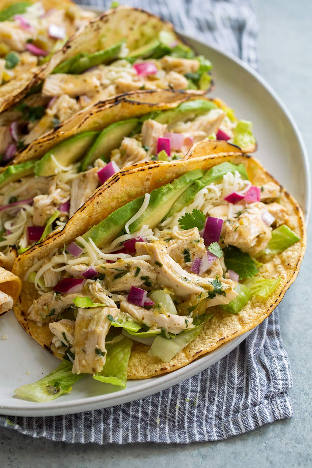 Salsa Verde Chicken Tacos Three salsa verde chicken tacos on serving plate.