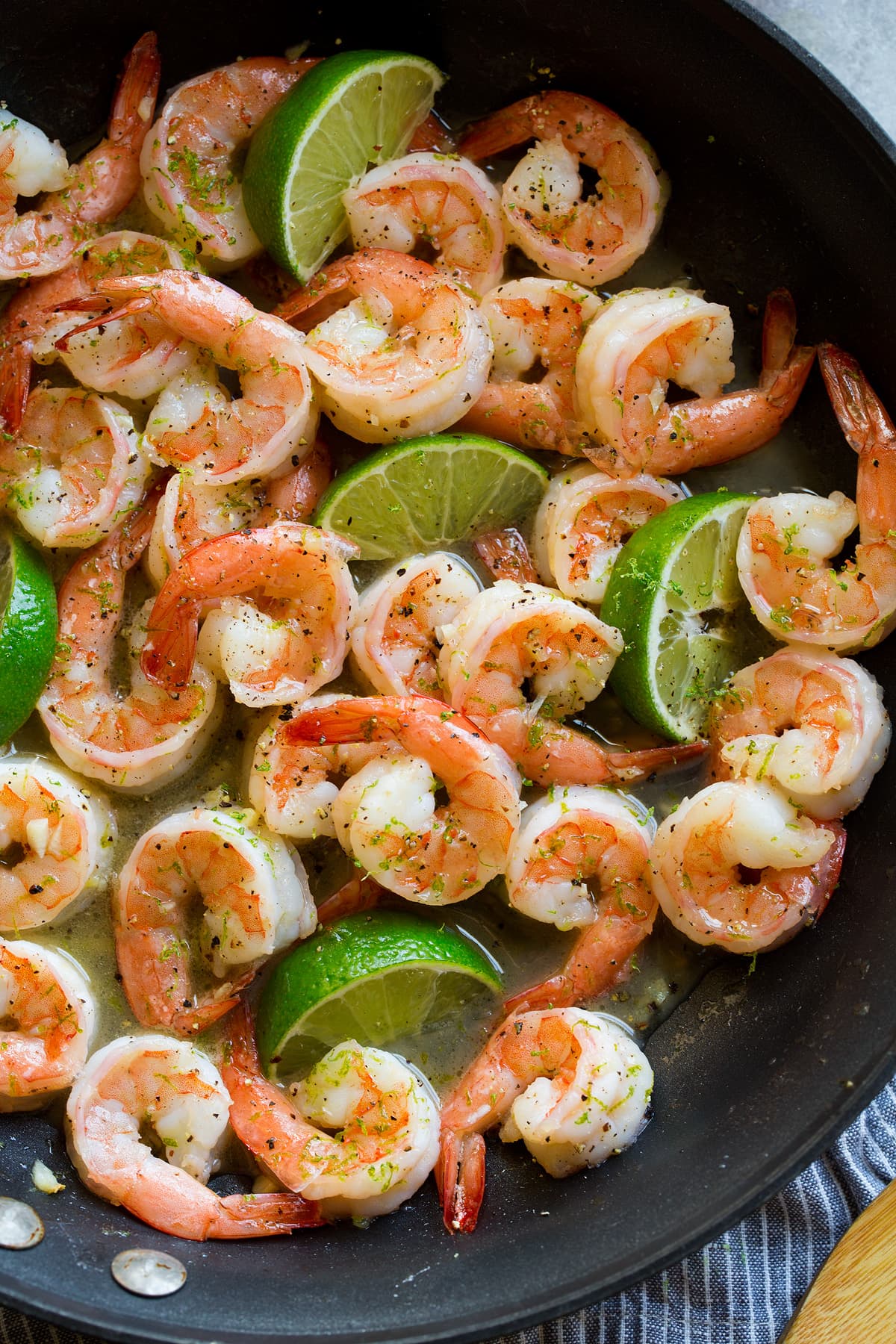 Shrimp with honey lime sauce in a black skillet.