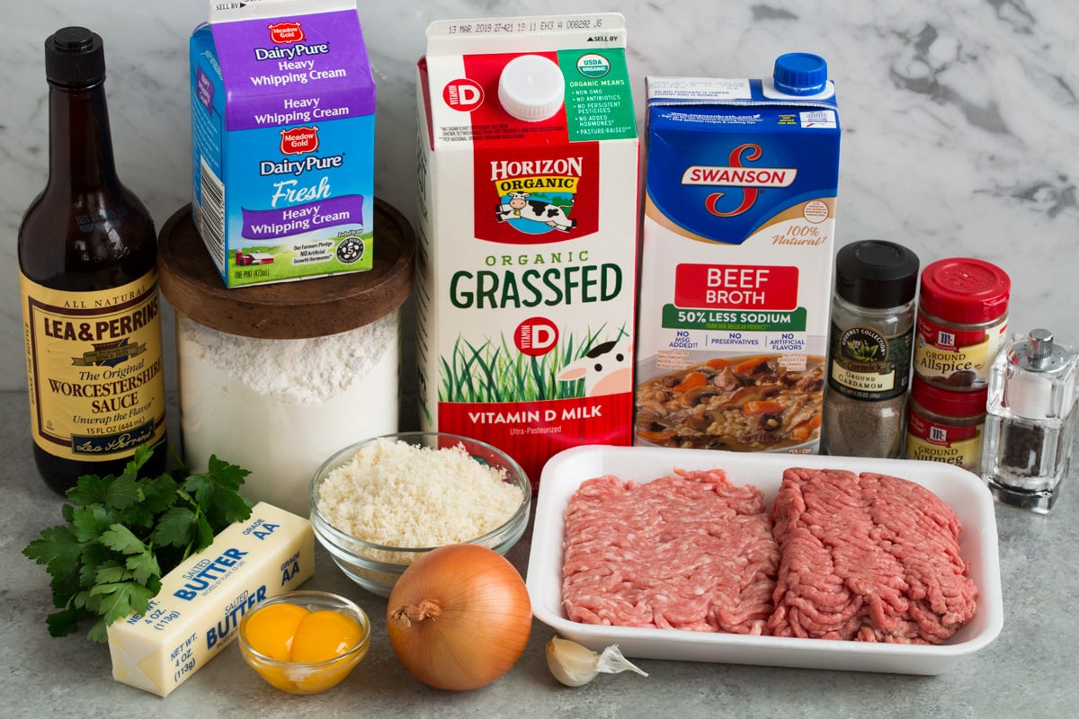 Ingredients needed for Swedish meatballs shown here including milk, fresh bread crumbs, spices, ground beef and pork, onion, garlic, butter, egg yolks, parsley, beef broth, milk, cream, flour and Worcestershire sauce.