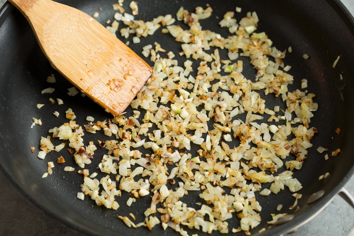 Sauteing onion and garlic in butter in large skillet.