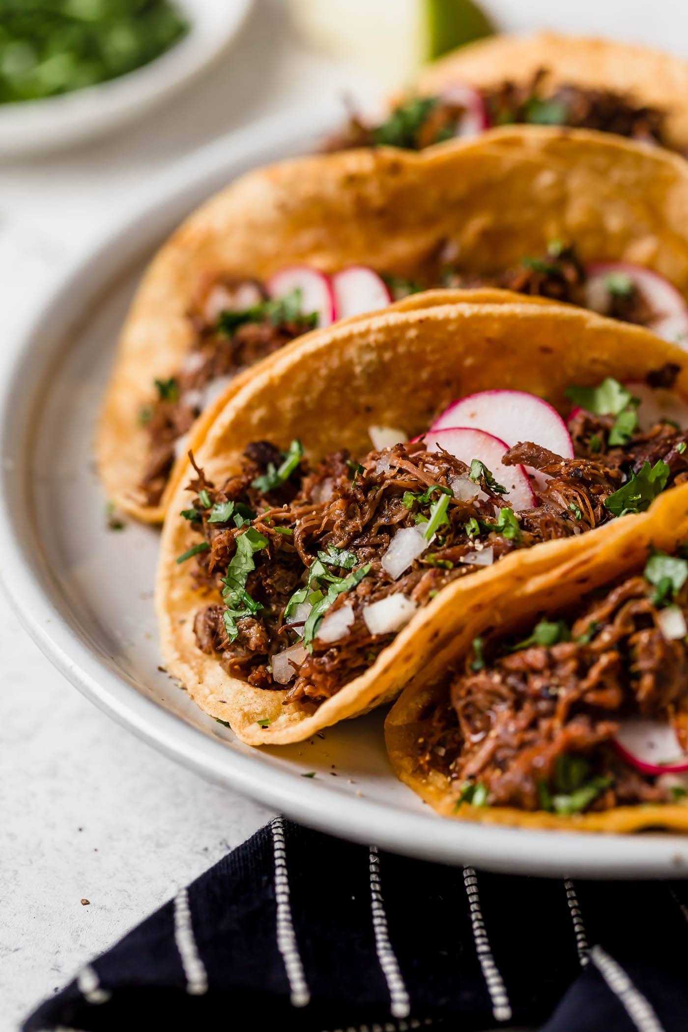Slow Cooker Barbacoa Beef Barbacoa beef layered into tacos