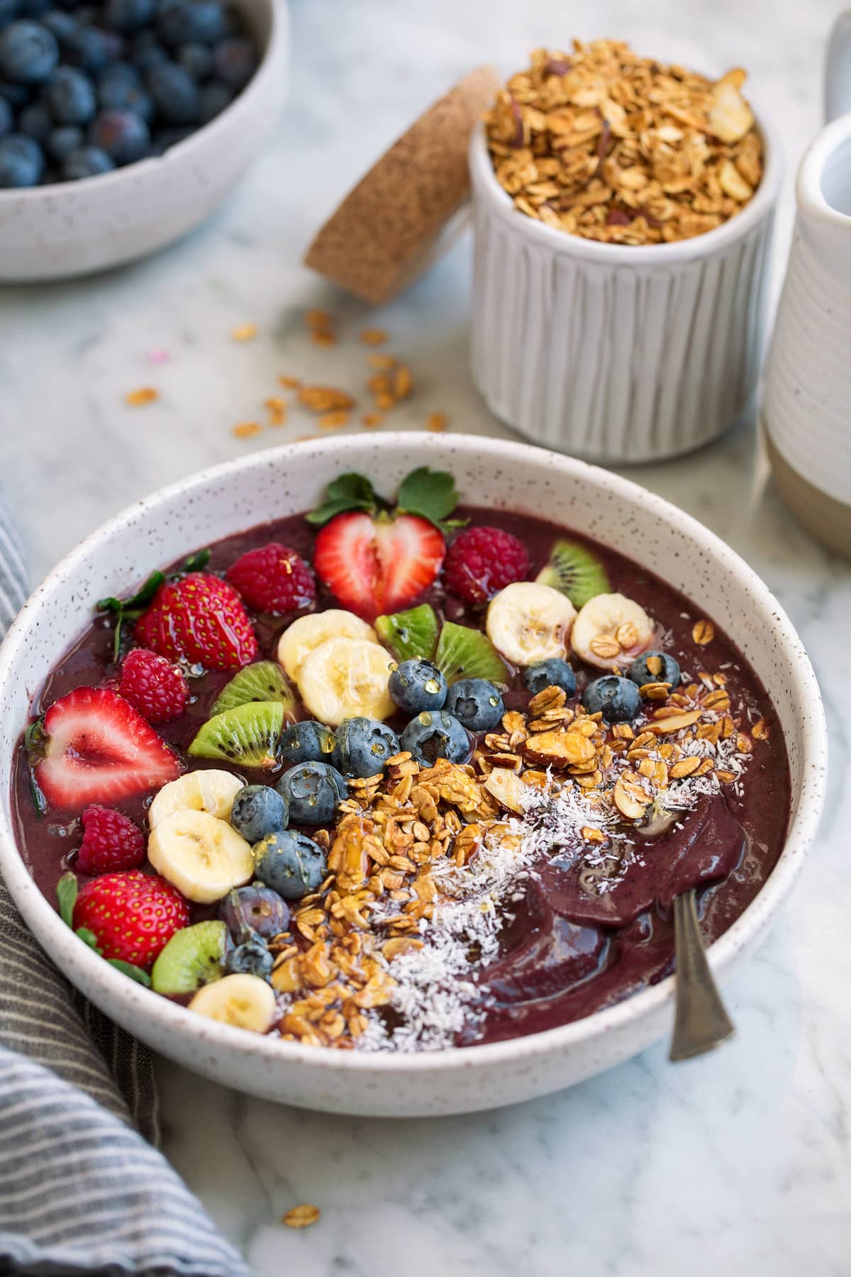Acai Bowl topped with fresh fruit, granola and coconut in a large bowl.