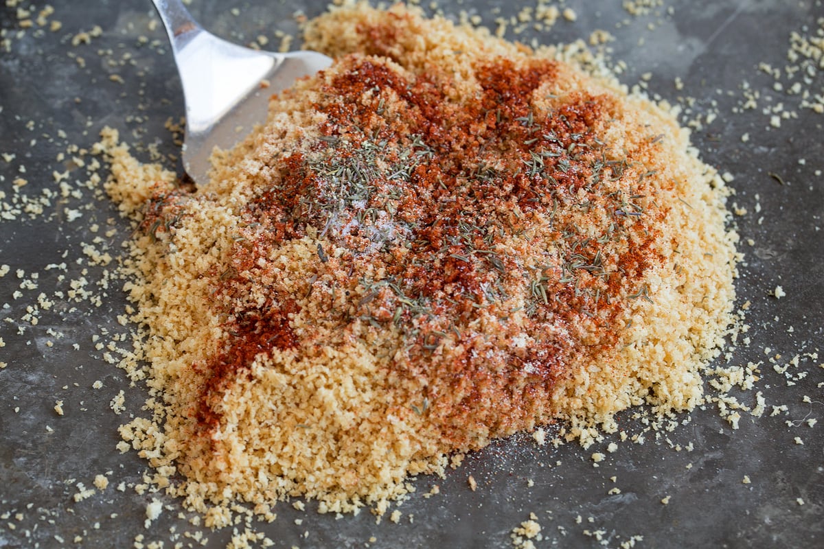 Tossing panko breadcrumbs with seasonings.