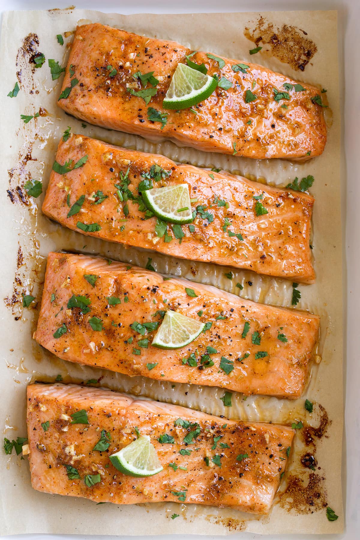 Close up overhead image of row of oven baked salmon fillets.