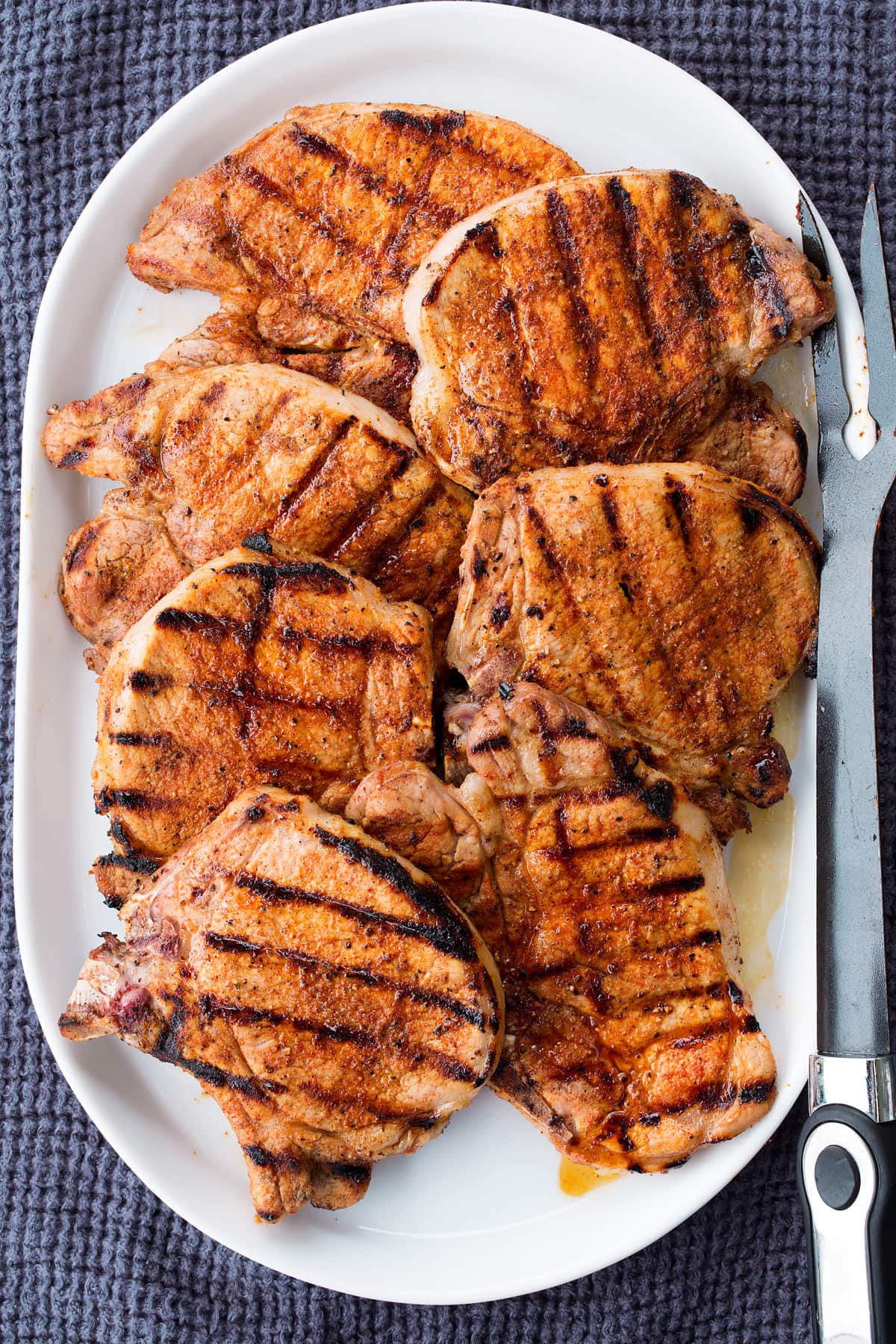 Grilled Pork Chops Grilled pork chops on a white oval platter.