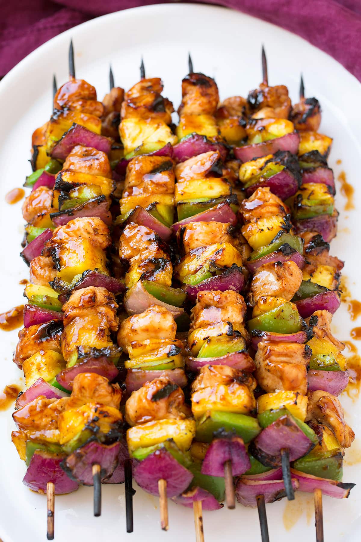 Grilled Hawaiian Chicken Kebabs on a white platter.