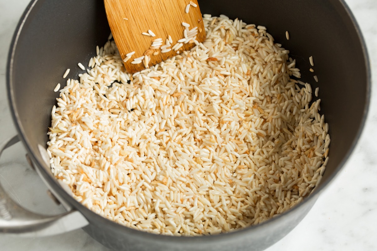 Sautéing rice in a saucepan.
