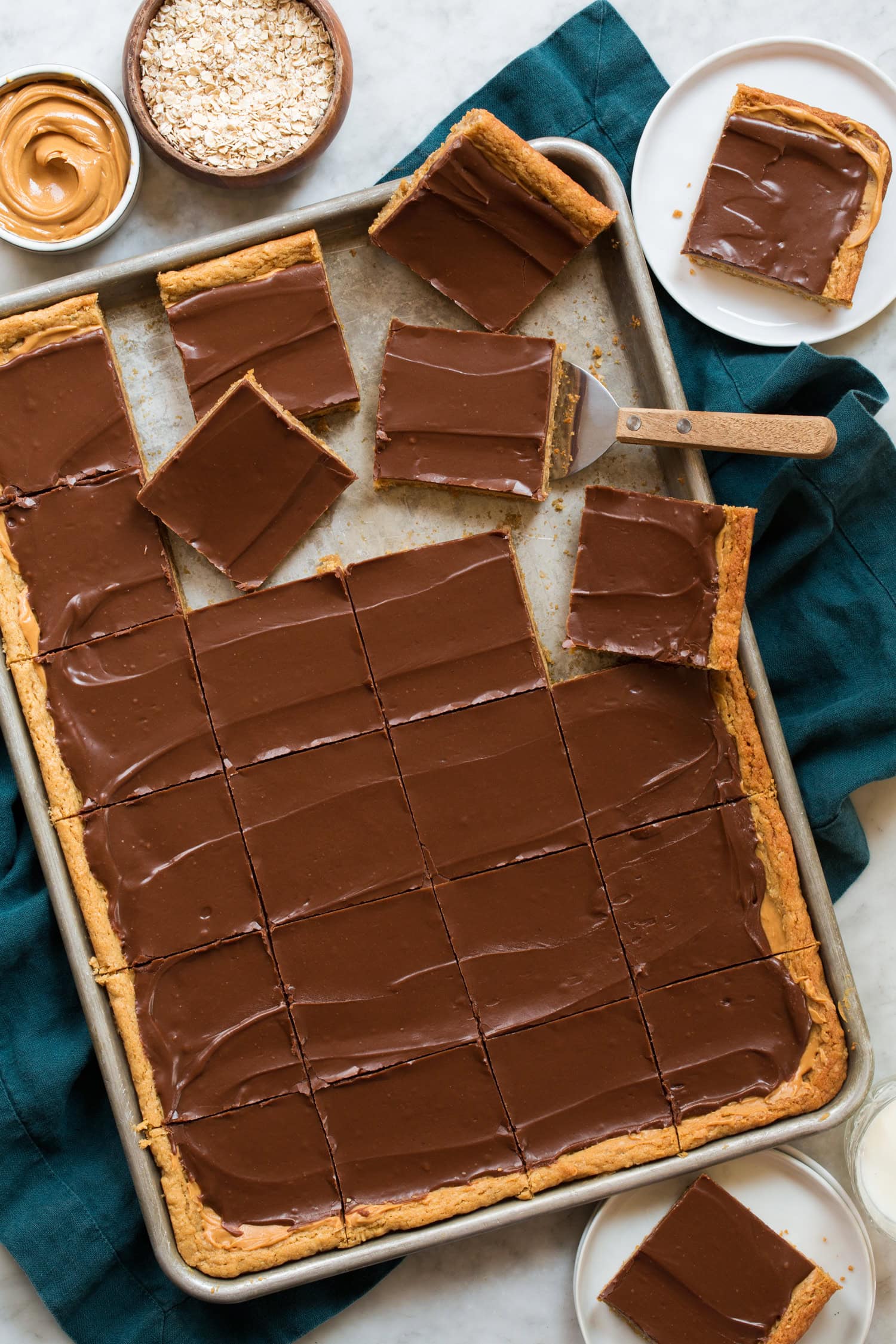 Sheet pan of peanut butter cookie bars sliced.