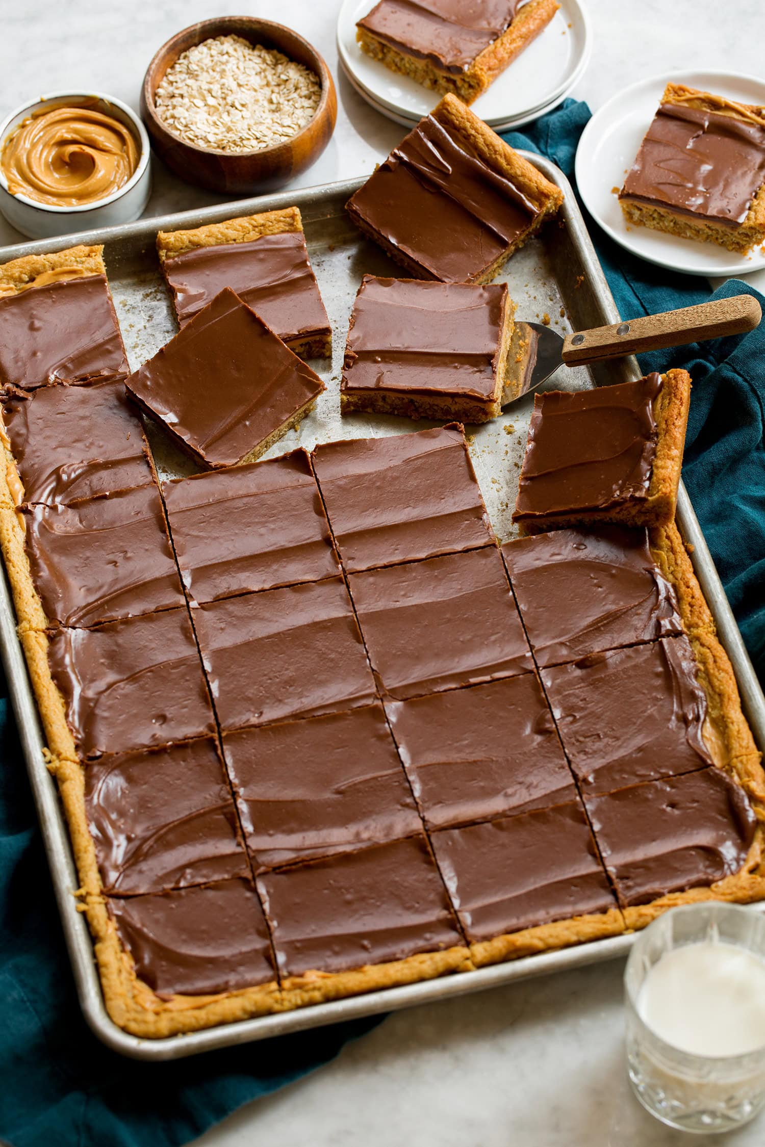 Sheet pan of peanut butter cookie bars sliced.