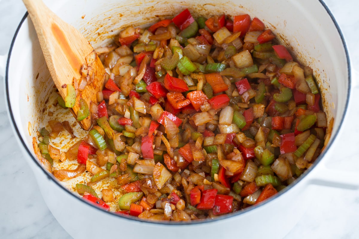 Adding spices to bell pepper mixture.
