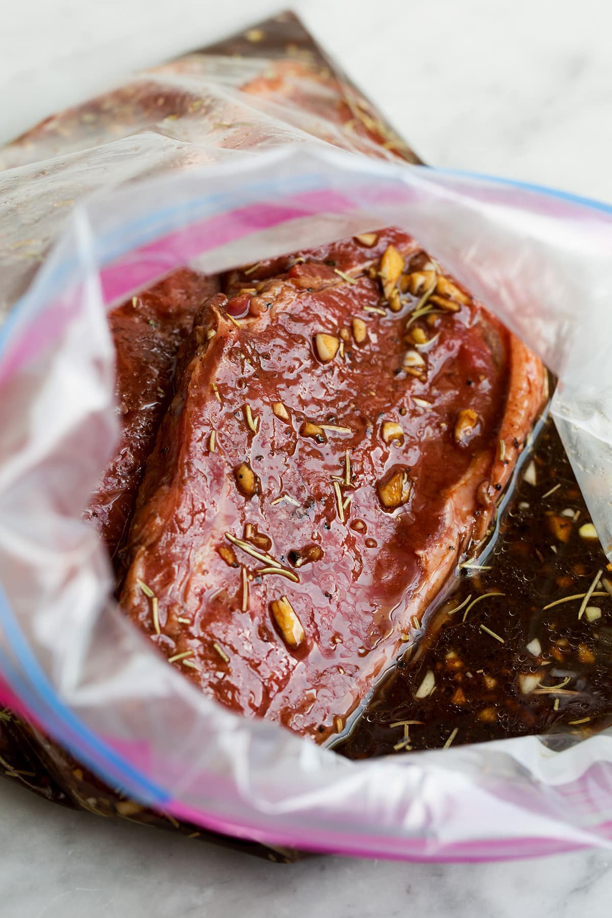 Steak soaking in a steak marinade.