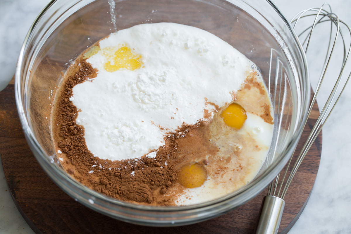 Mixing liquid ingredients in a glass bowl for baked oatmeal.