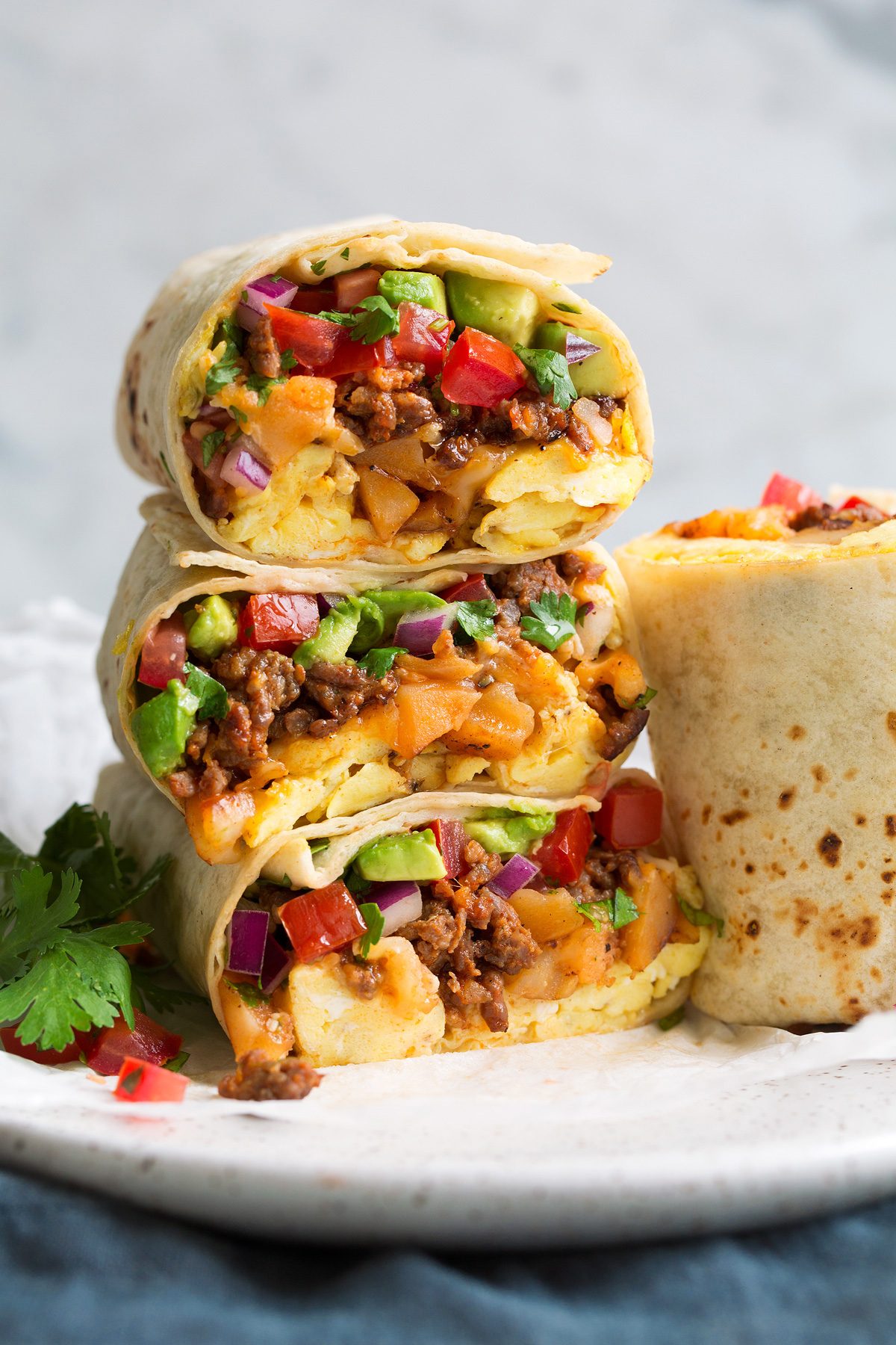 Stack of breakfast burritos.