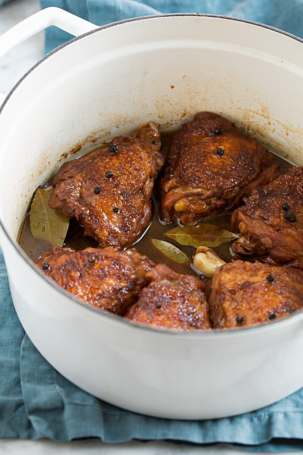 Chicken Adobo - easy Filipino chicken recipe made with soy sauce, vinegar, garlic and a hint of brown sugar. Tastes similar to teriyaki sauce but not quite so sweet. A perfect weeknight dinner! #chicken #adobo #recipe Finished chicken adobo in a pot.