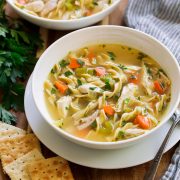 Homemade chicken noodle soup in two serving bowls.