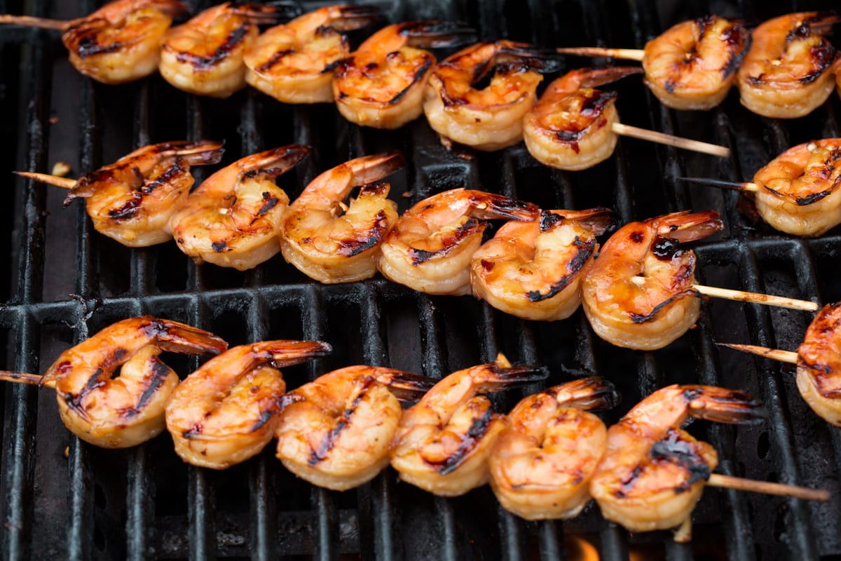 Grilled Shrimp with Honey Garlic Marinade - only 4 ingredients in this fast, easy and flavorful marinade! Perfect for a quick dinner! #shrimp #marinade #grilledshrimp #dinner #recipe Shrimp skewers on the grill.