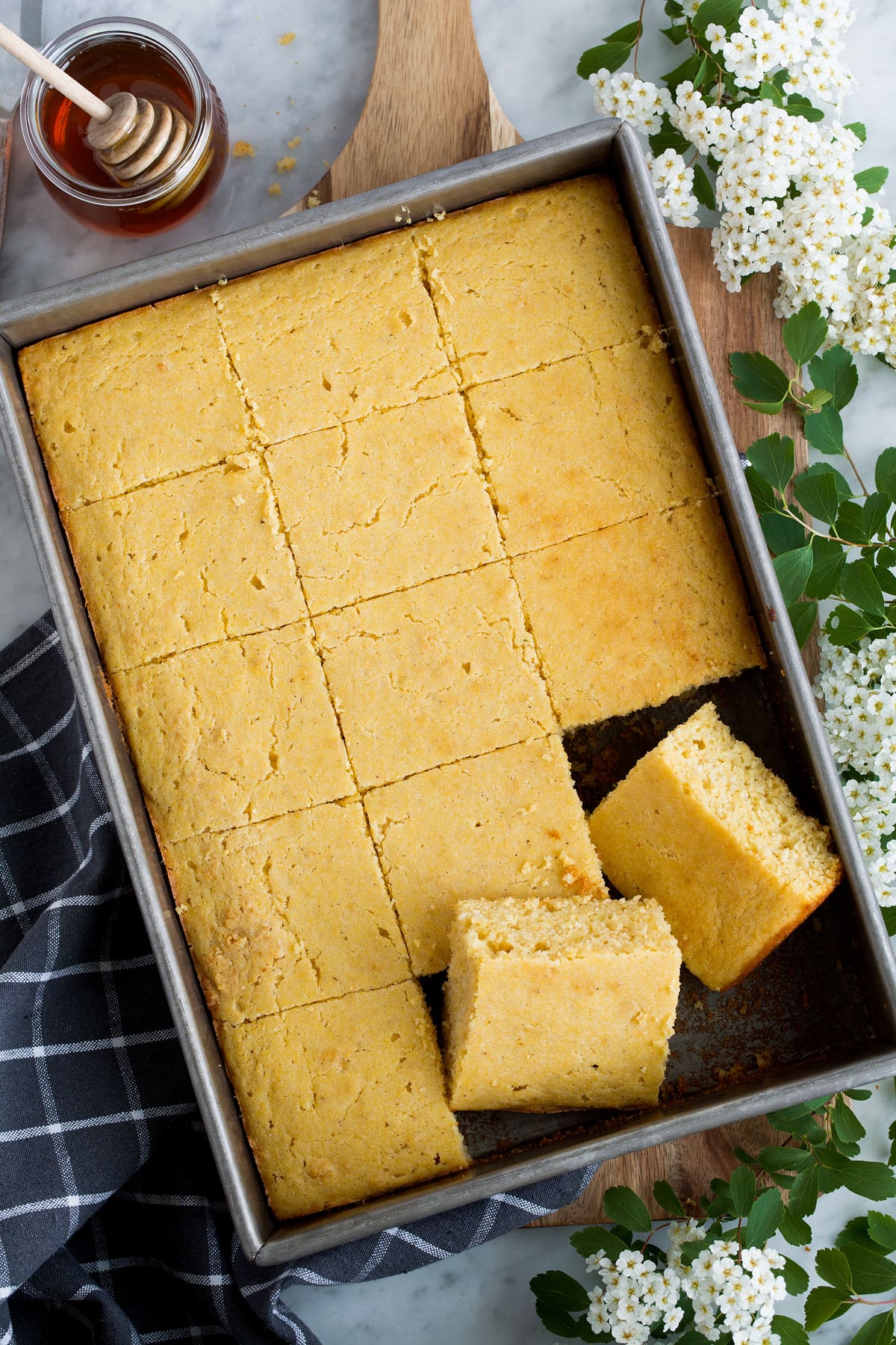 Overhead image of cornbread cut into squares in a baking dish.