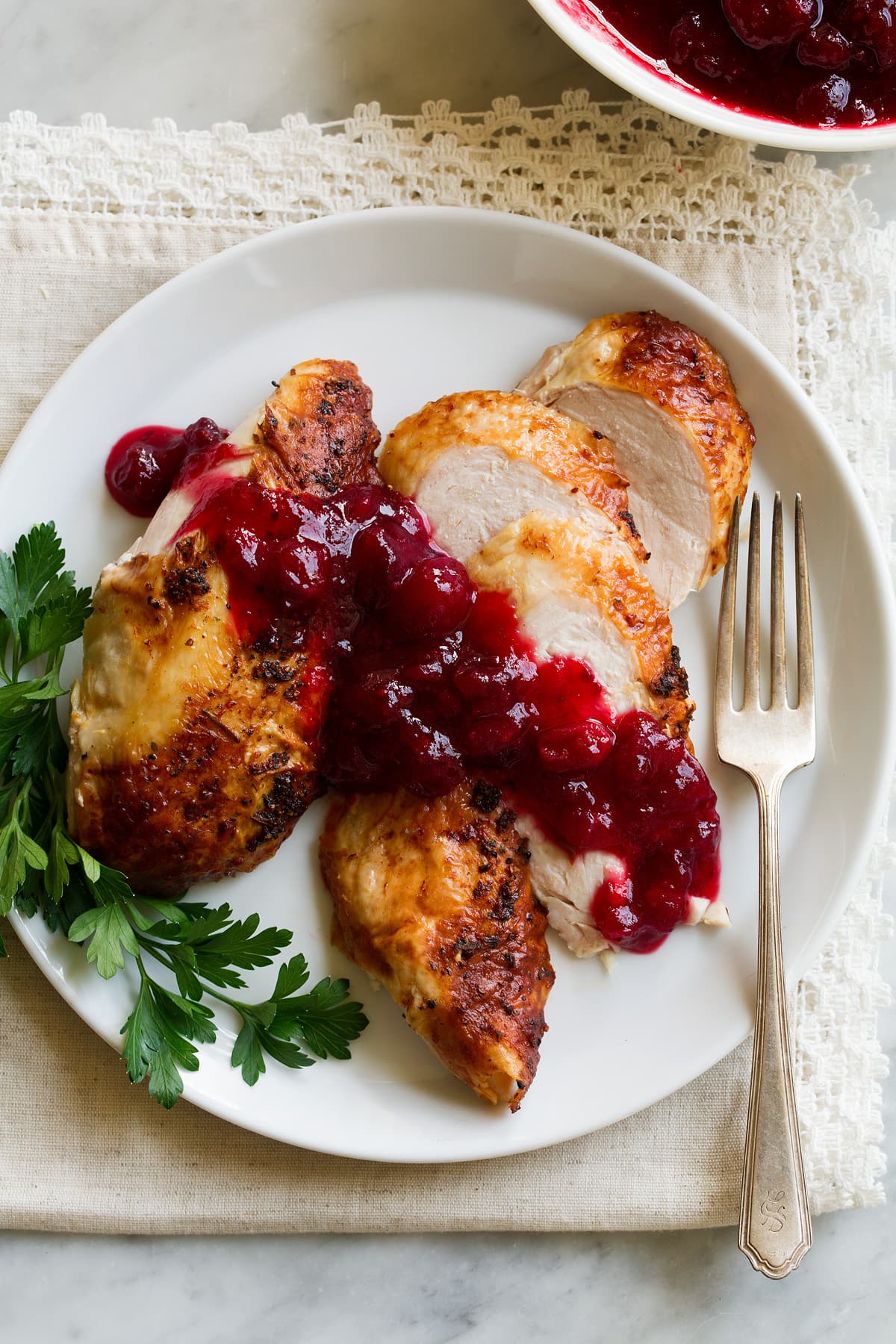 Cranberry sauce spread over chicken.