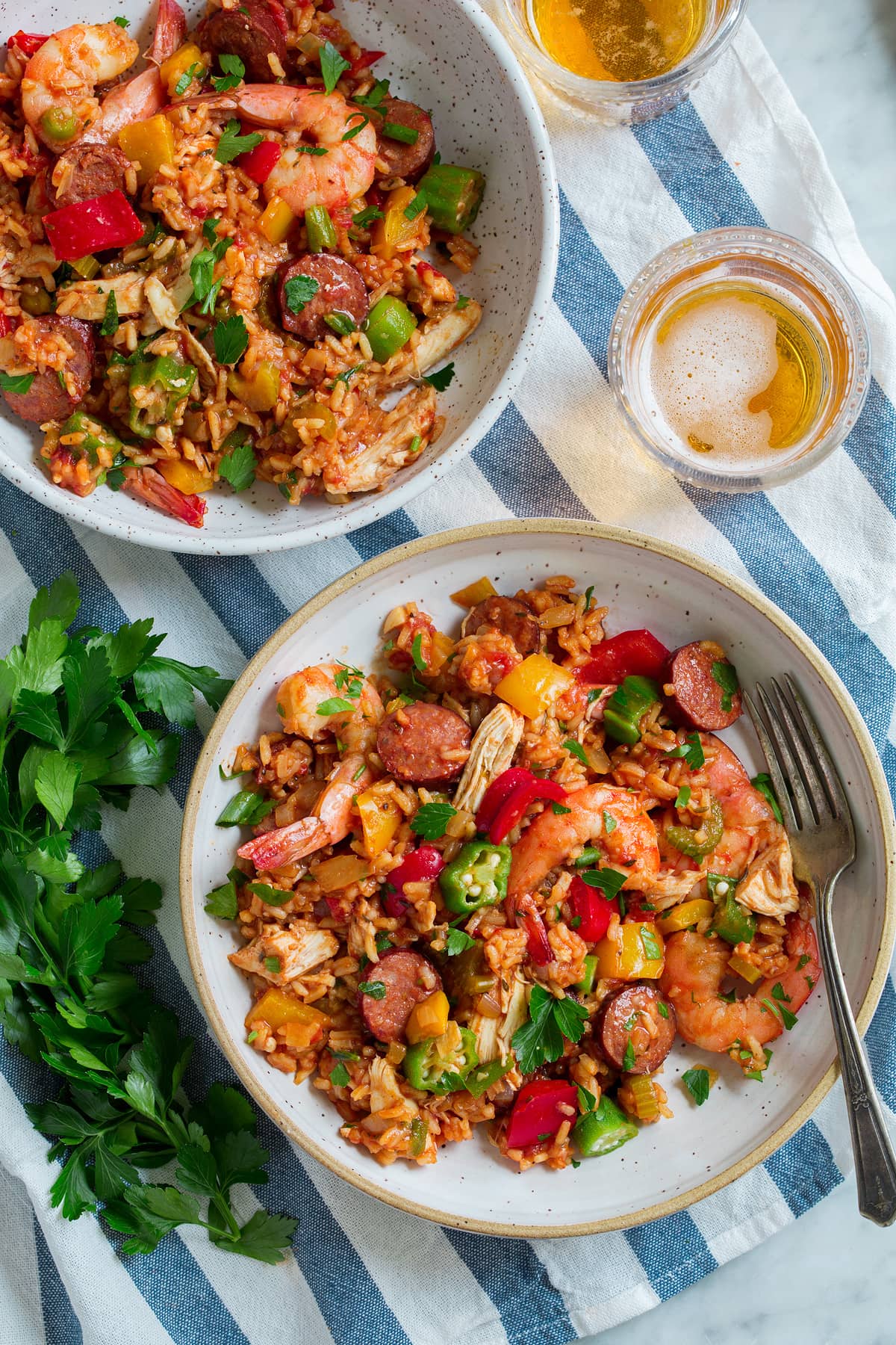 Two servings of jambalaya in bowls.