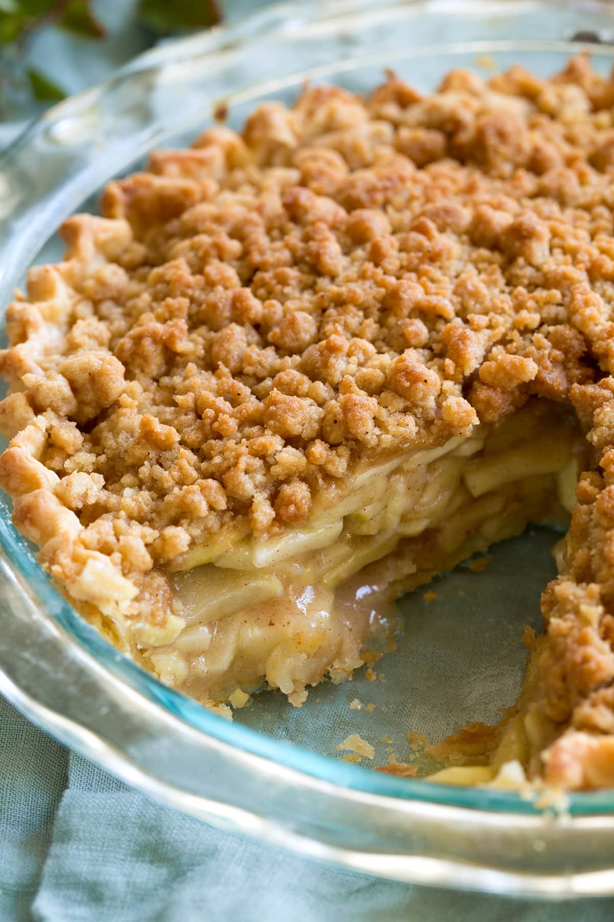 Close up image of Dutch apple pie in a glass pie pan.