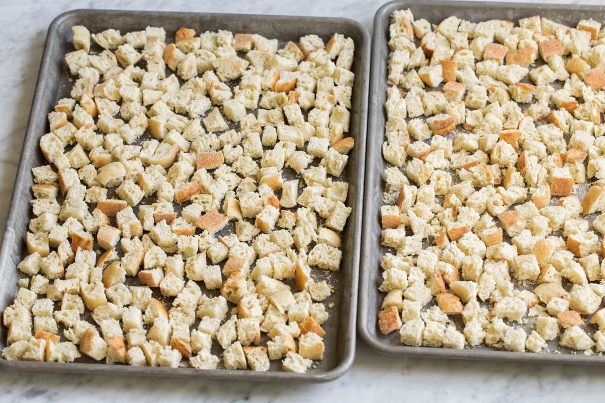 Bread cubes on a baking dish after drying in the oven.