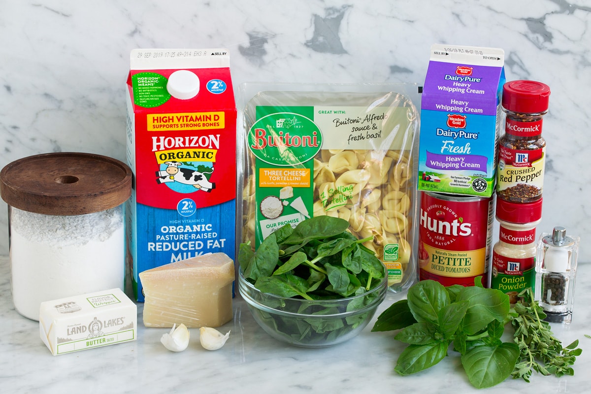 Image of ingredients that go into spinach and tomato tortellini.