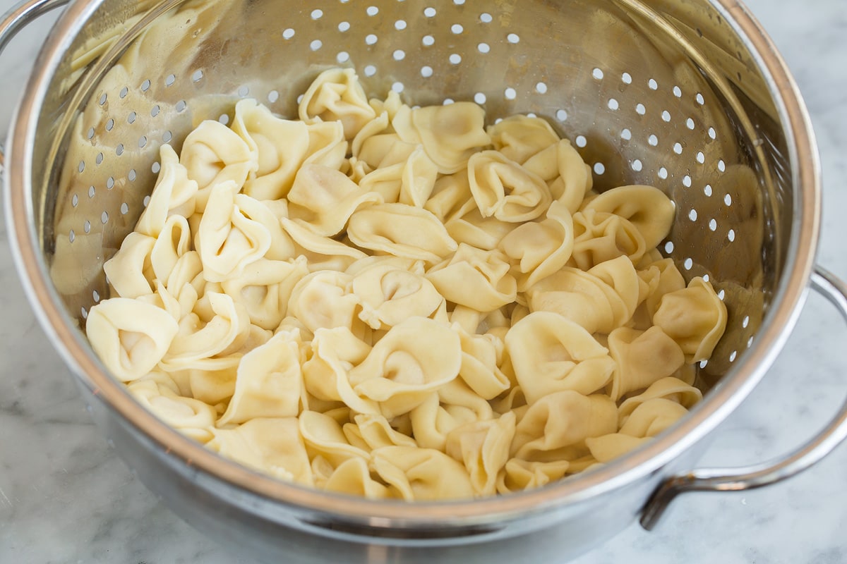 Tortellini draining in a colander.