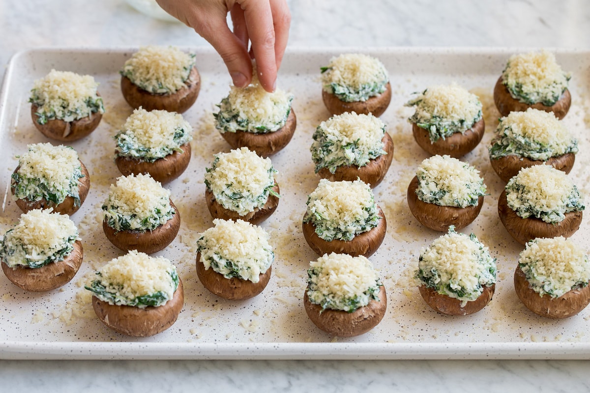 Stuffed Mushrooms Topping stuffed mushrooms on baking sheet with panko topping.