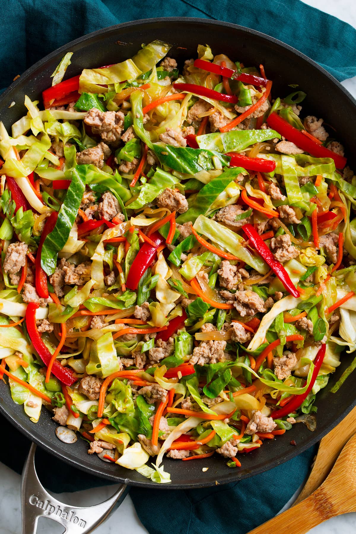 Close up image of egg roll in a bowl in a skillet.