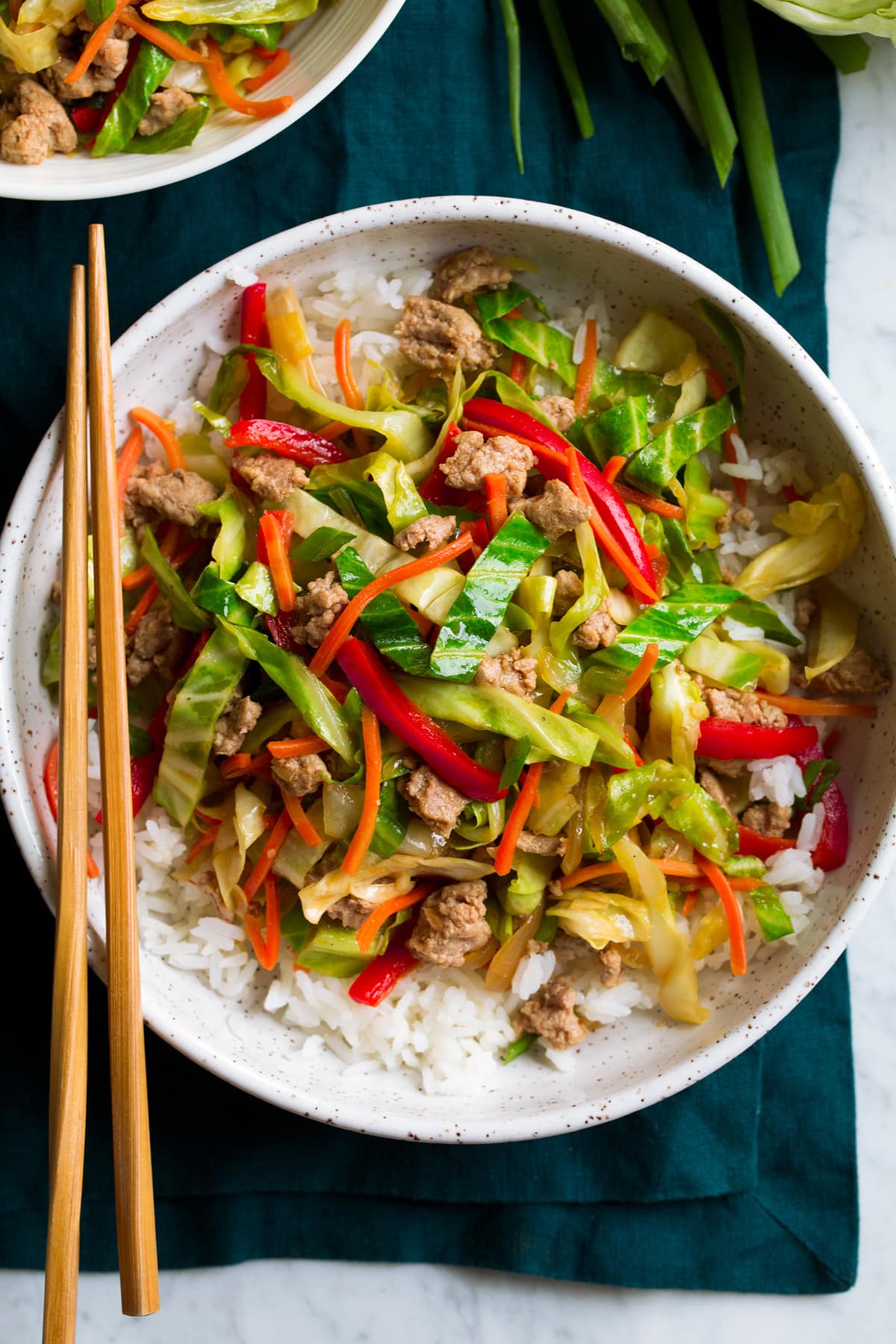 Showing possible variation of egg roll in a bowl served over white rice.