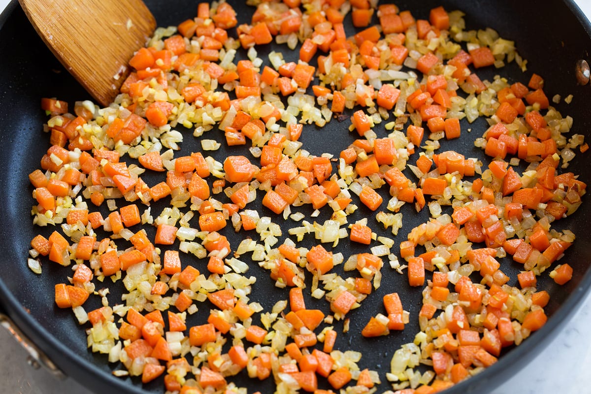 Fried Rice Sautéing carrots, onions, ginger and garlic in a skillet.