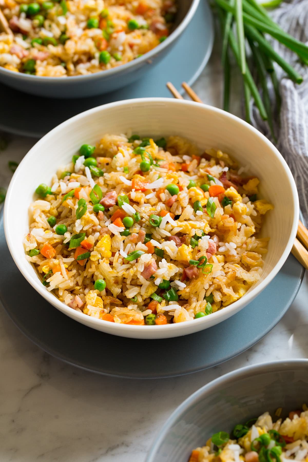 Fried Rice Serving of fried rice in a white bowl set over a blue plate.