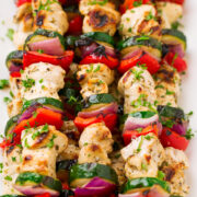 Greek Chicken Kebabs on skewers with marinated chicken breast, zucchini, bell pepper and red onion.