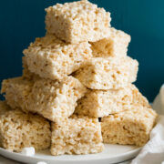 Stack of cut rice krispie treats on a platter.