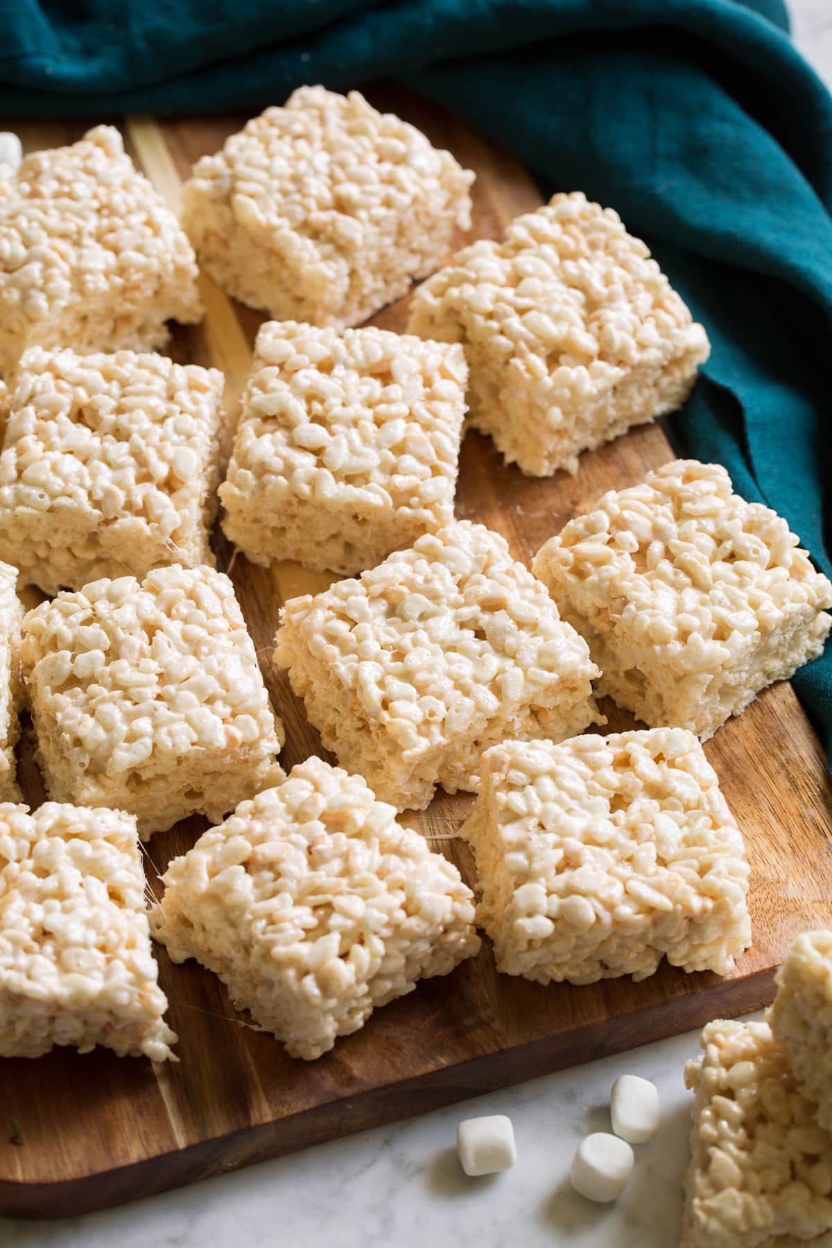 Rice krispie treats on a cutting boards.