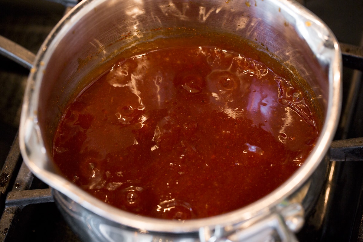 Homemade BBQ Sauce BBQ sauce simmering on stovetop.