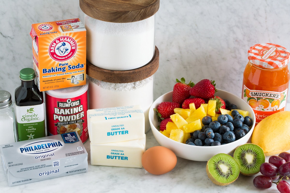 Fruit Pizza Image of fruit pizza ingredients including flour, sugar, baking powder, baking soda, vanilla, egg, cream cheese, salt, fresh fruit and jam.