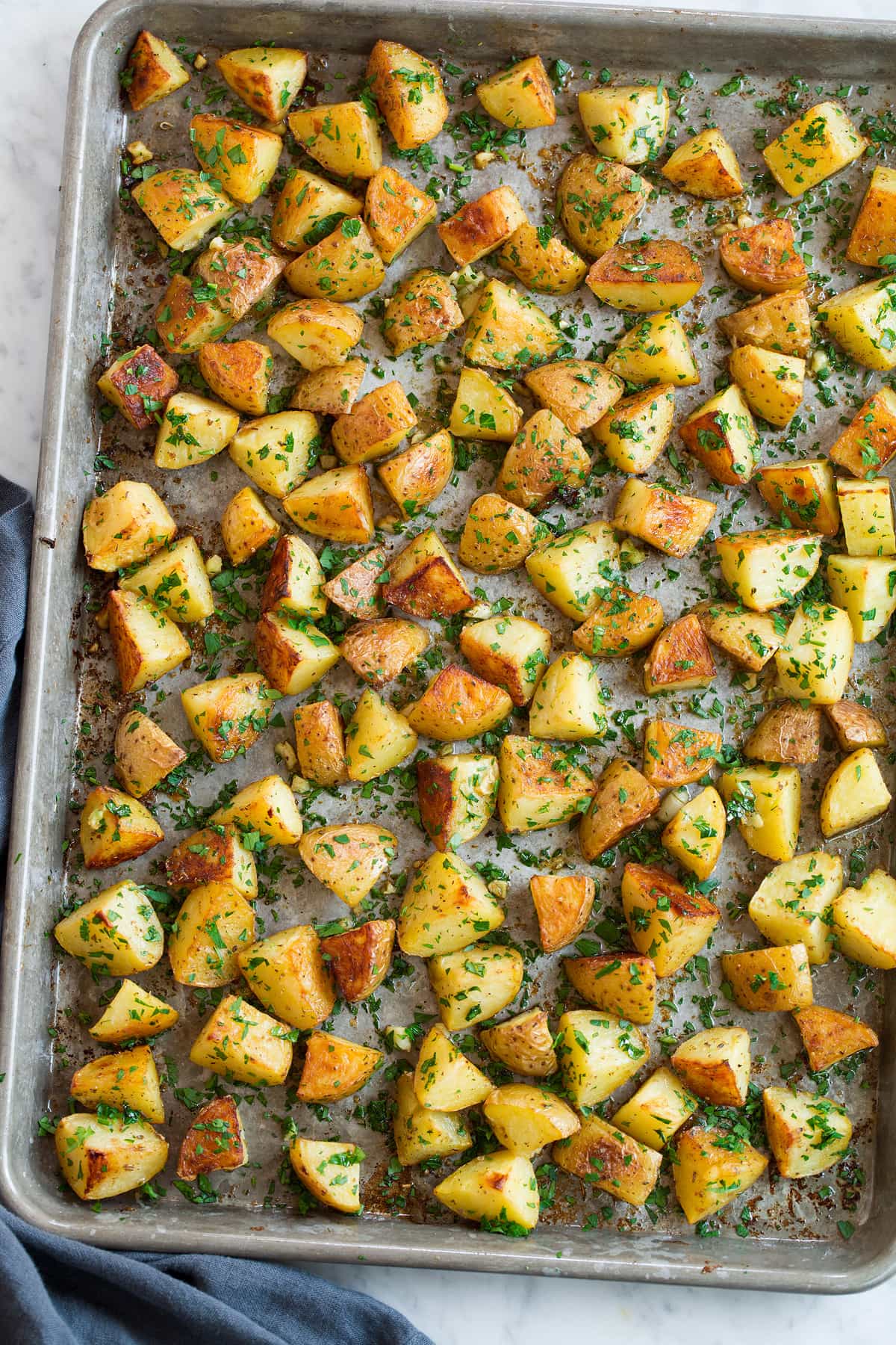 Lemon seasoned yukon roasted potatoes on a baking sheet shown overhead.