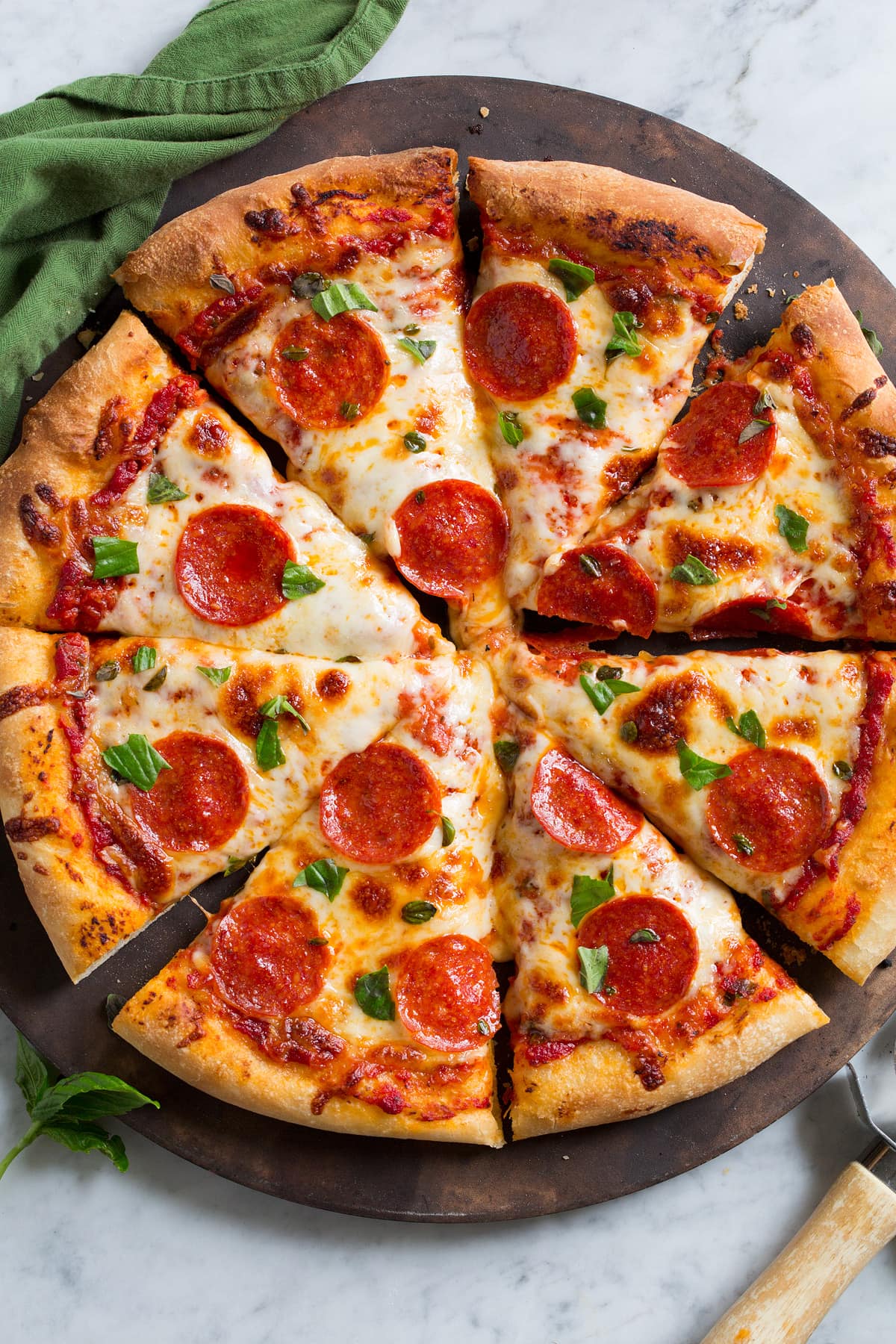 Overhead image of pepperoni pizza with homemade crust. Pizza is cut into 8 slices.