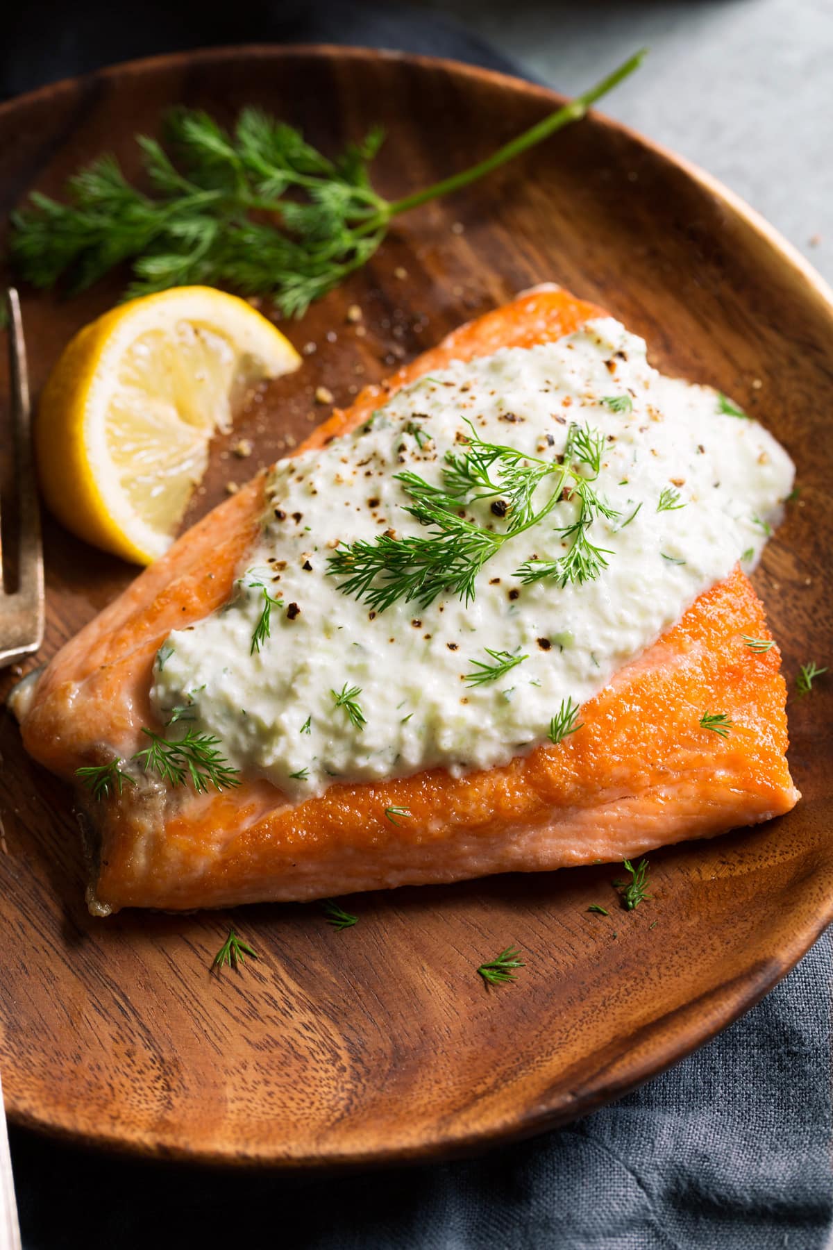 Homemade Tzatziki Sauce Showing serving suggestion pairing tzatziki sauce atop a salmon fillet.