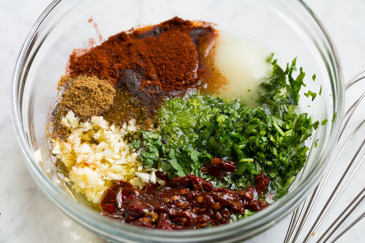 Carne Asada Carne asada marinade in a glass mixing bowl shown before mixing.