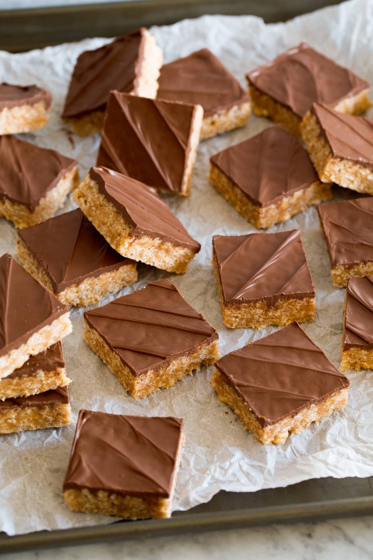 Scotcheroos Scotcheroos scattered out on crinkled parchment paper.