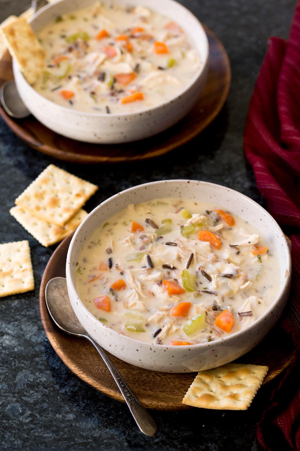 Two servings of chicken and wild rice soup in serving bowls.