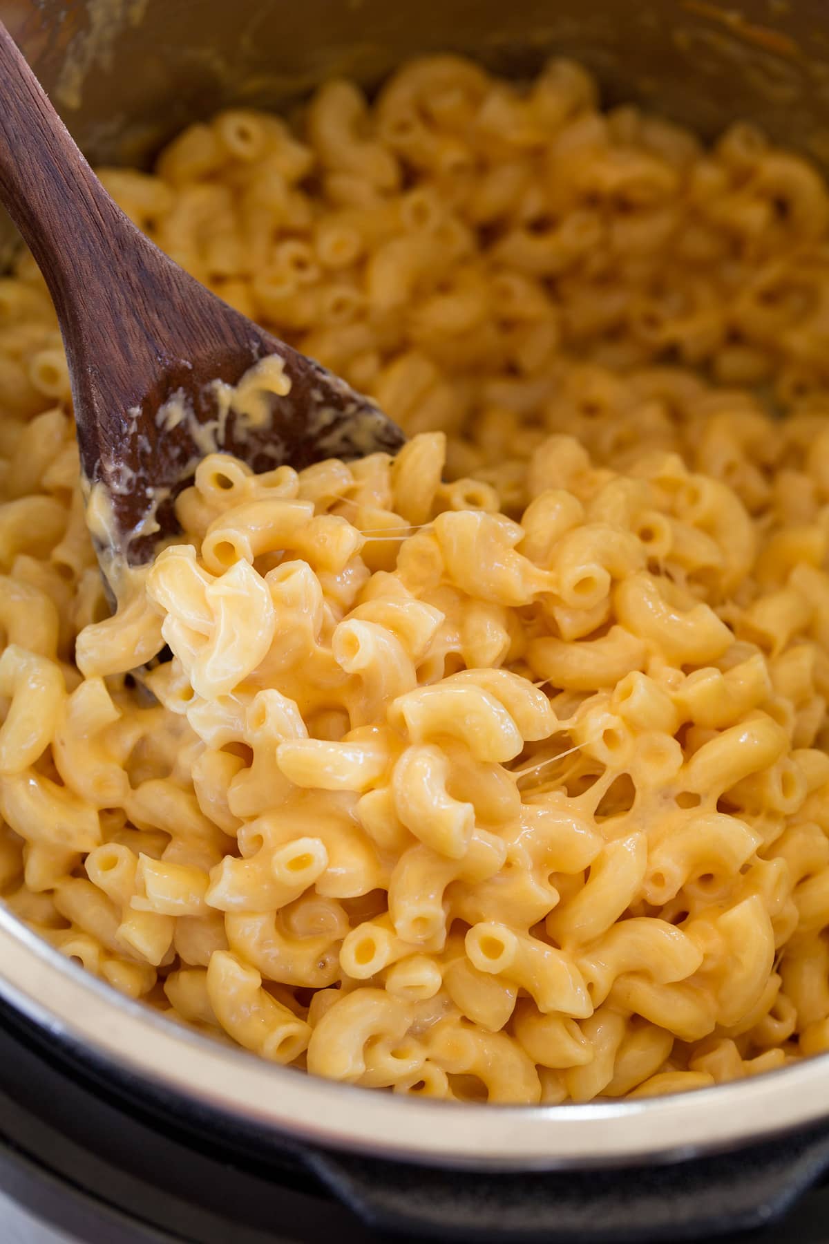 Instant Pot Mac and Cheese Close up image of mac and cheese being scooped from Instant Pot.