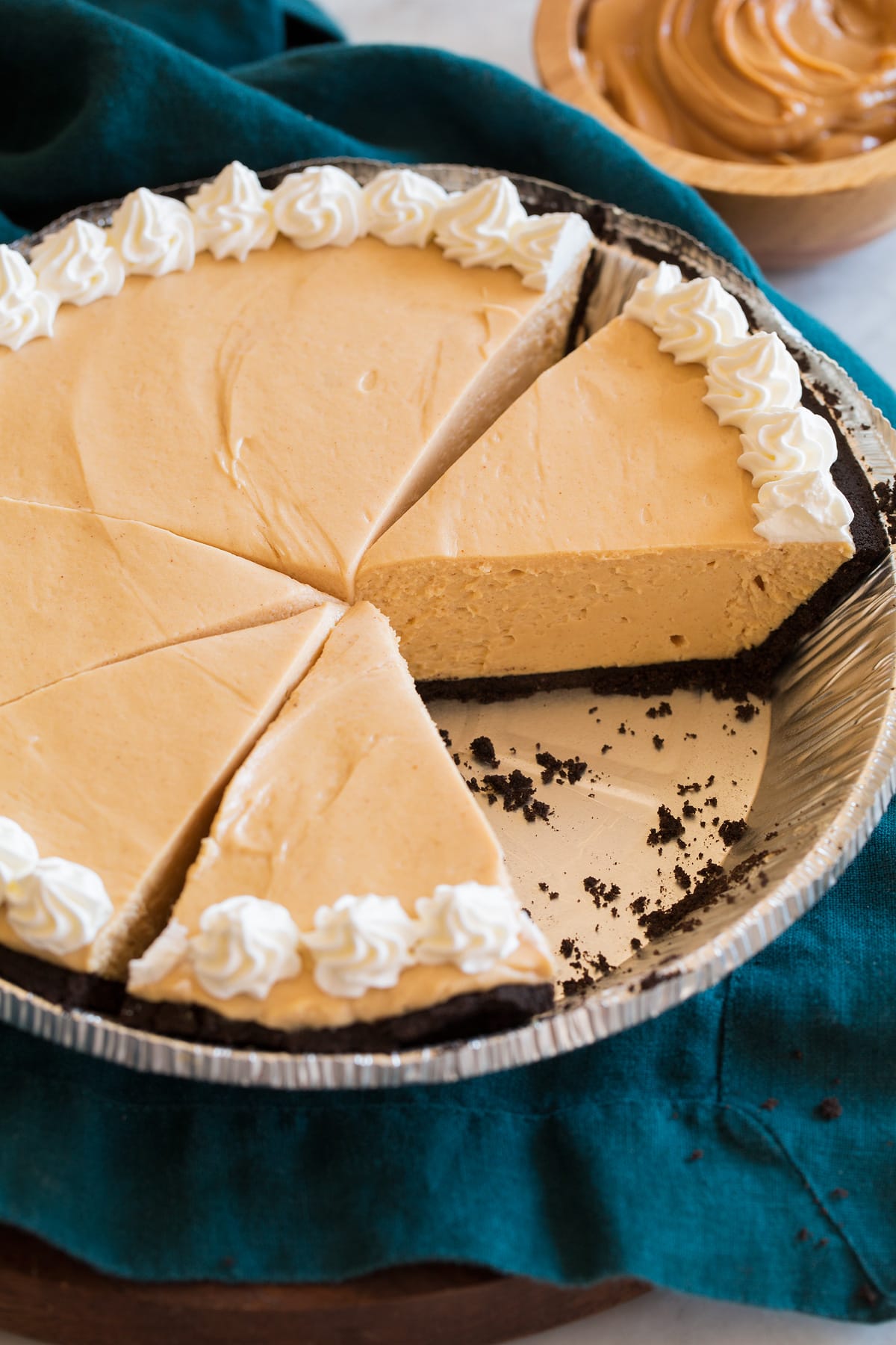 Peanut butter pie shown sliced in an aluminum pie dish.