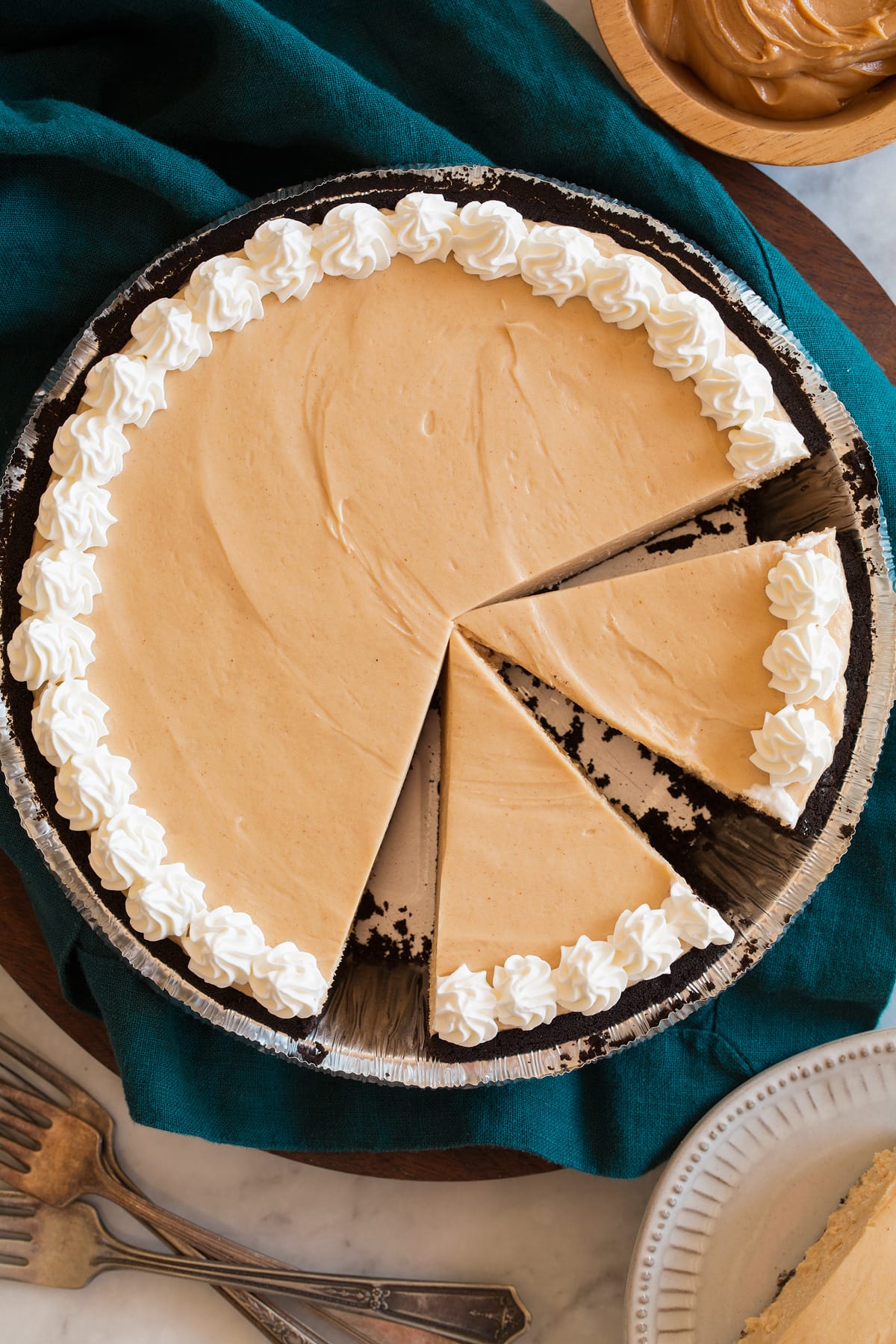 Overhead image of peanut butter pie with a few slices cut.