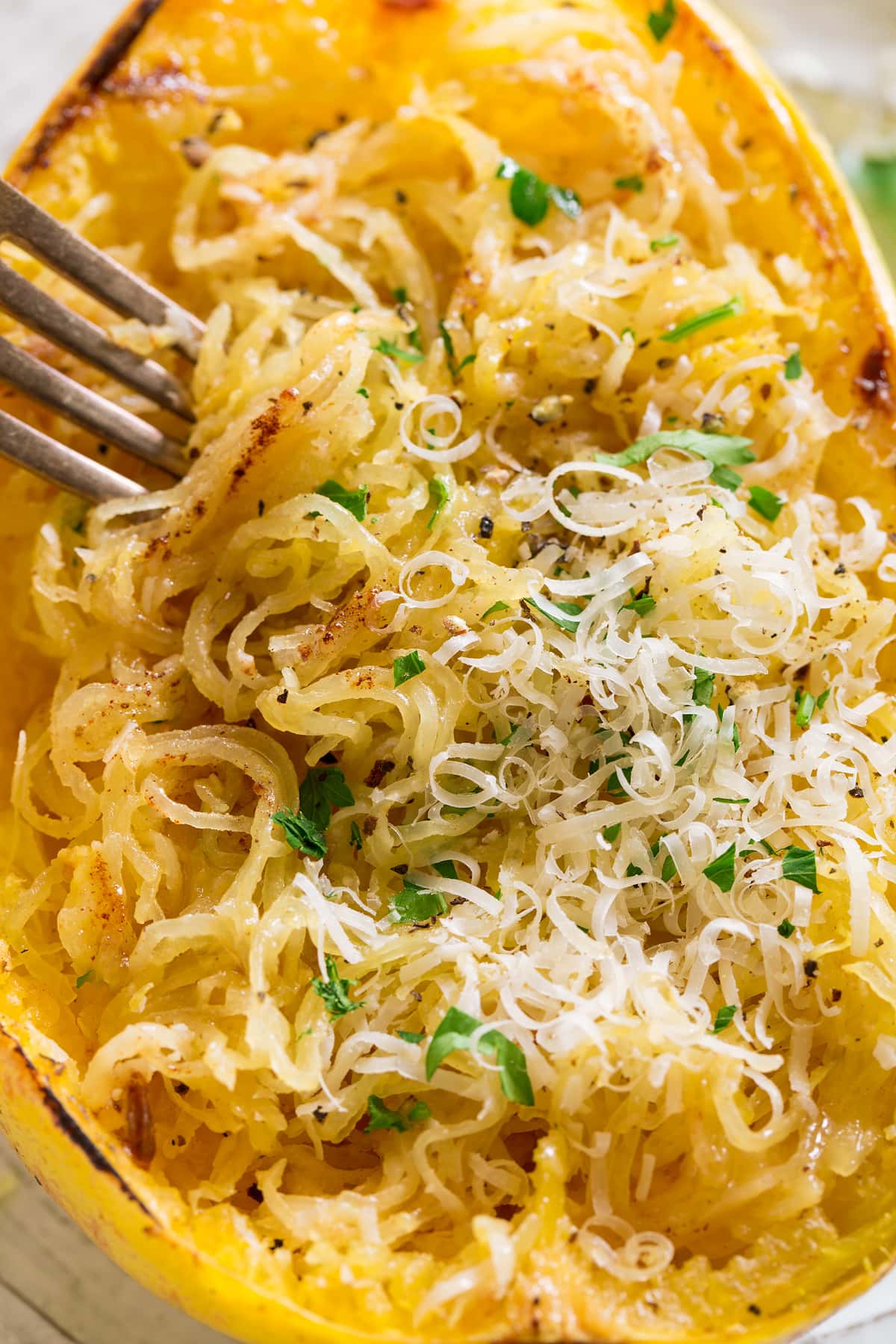 Roasted Spaghetti Squash with Browned Butter and Parmesan Close up image of roasted spaghetti squash shredded into strings, topped with browned butter and parmesan.