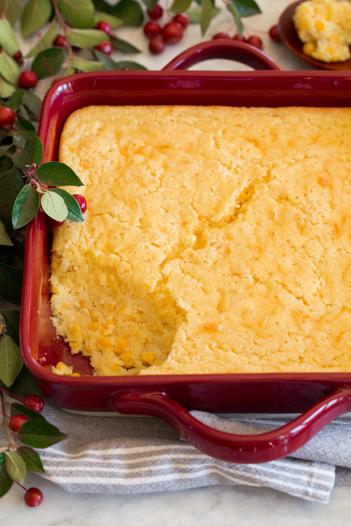 Corn casserole shown from the side with a scoop removed.