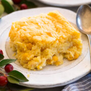 Single serving of corn casserole shown on a white plate with a spoon to the side.